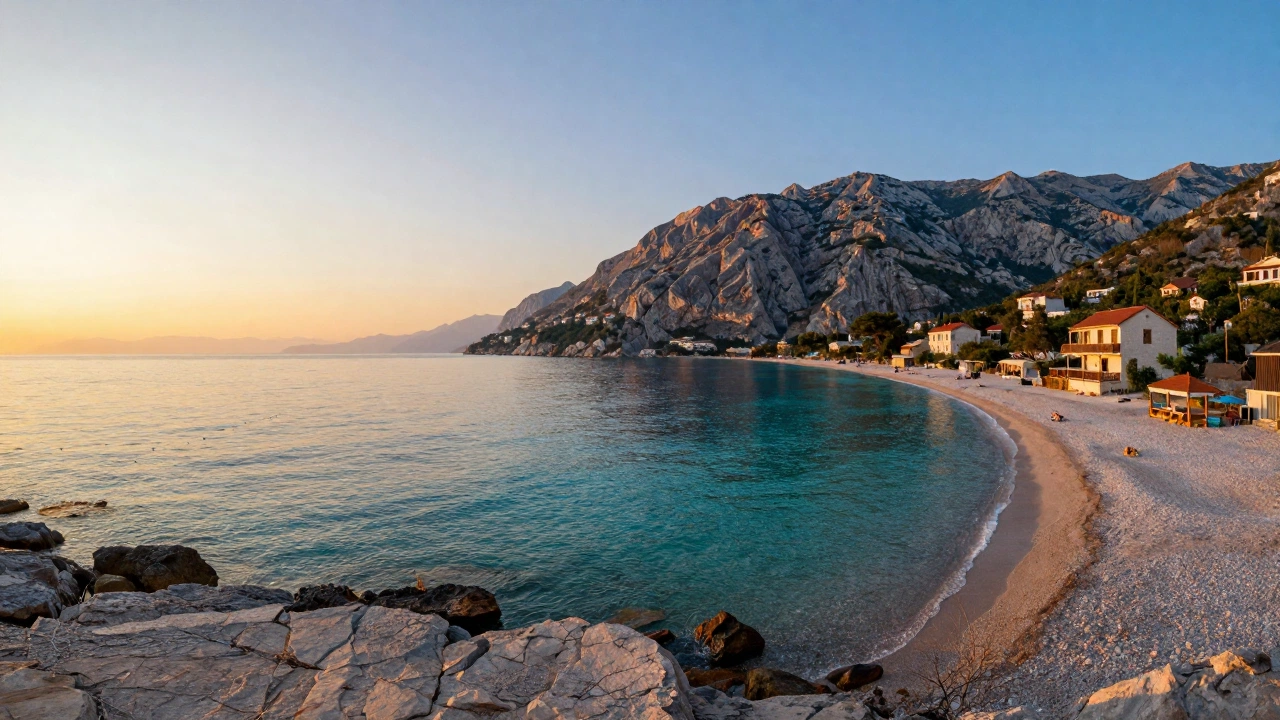 A serene coastal landscape along the Albanian Riviera at sunset, featuring pristine beaches with clear turquoise water, rocky cliffs, and sparse, charming beachfront houses, evoking a peaceful and wallet-friendly vacation atmosphere.